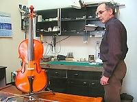 Srevan Rakić string instruments maker in his workshop with violin